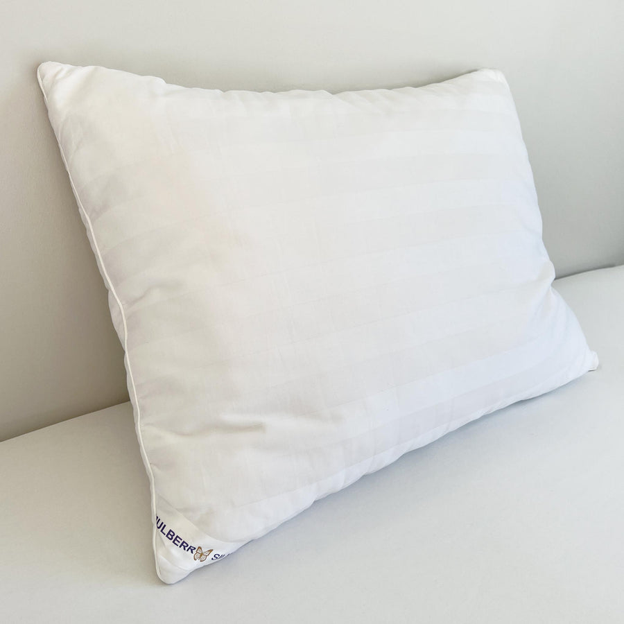 Mulberry silk pillow on a made bed