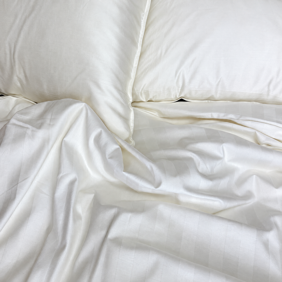 Classic White 320TC damask stripe cotton duvet cover on a bed, viewed from above