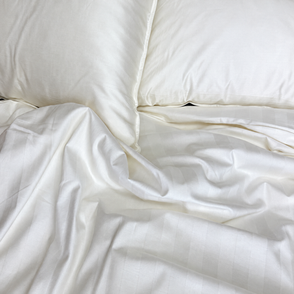 Classic White 320TC damask stripe cotton duvet cover on a bed, viewed from above